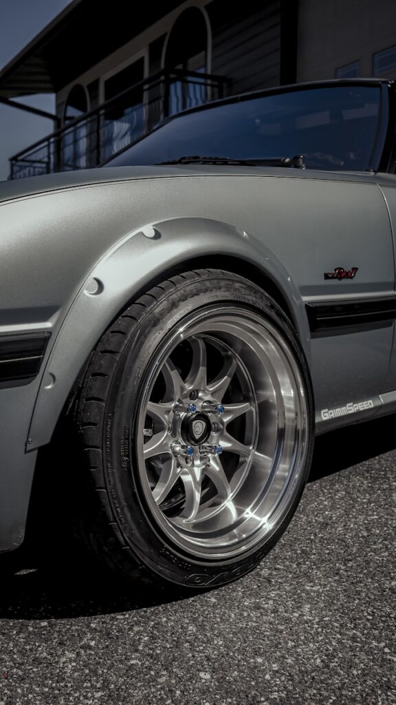 a silver sports car parked in front of a building