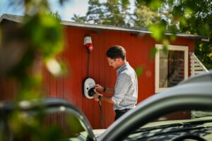 Man plugging in an electric car charger.