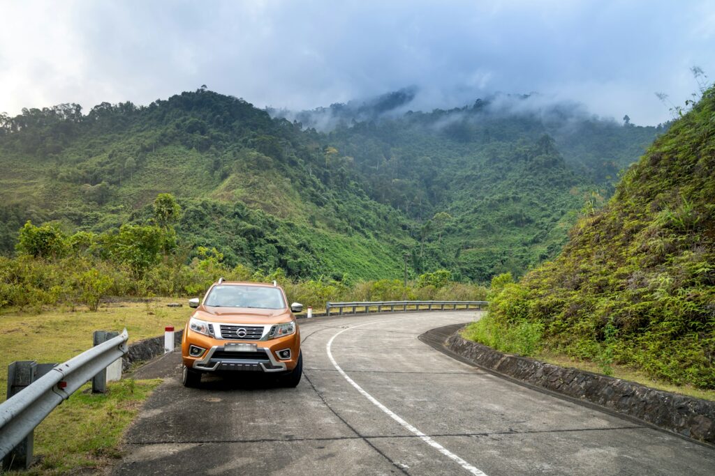 a car parked on the side of a mountain road