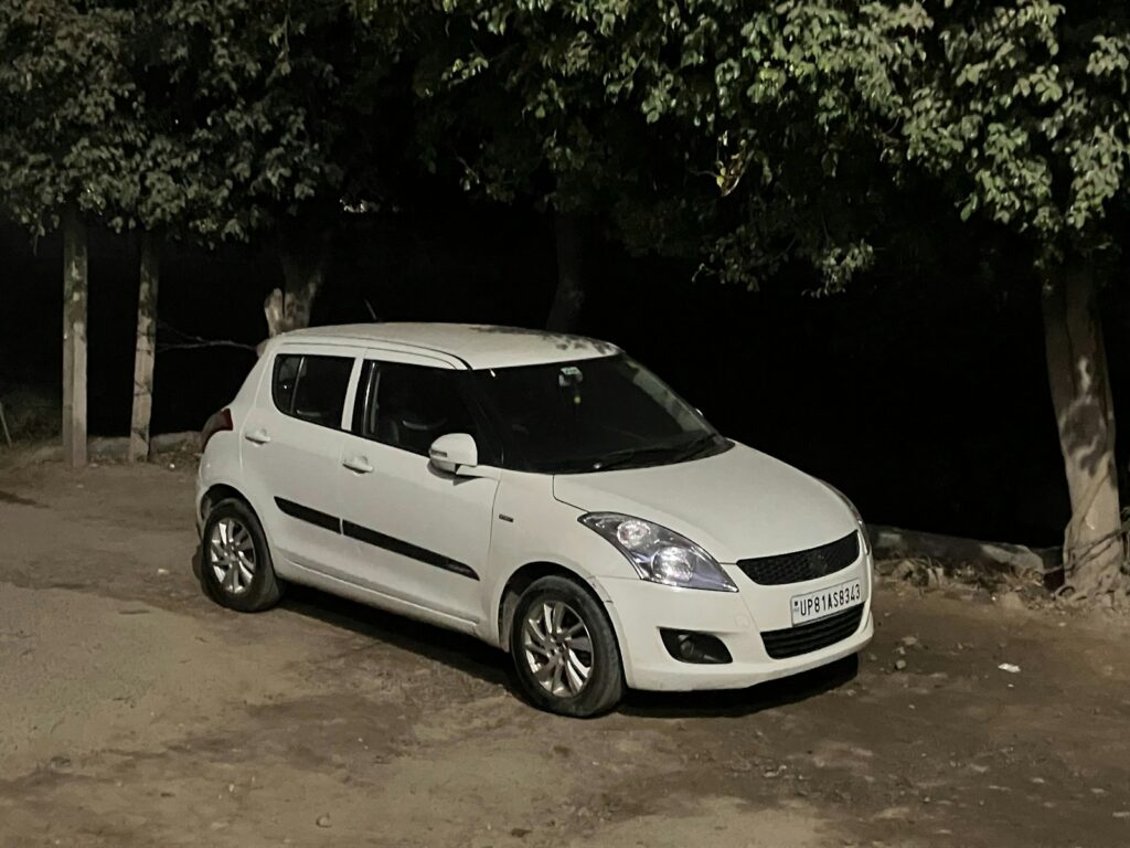a small white car parked in a parking lot