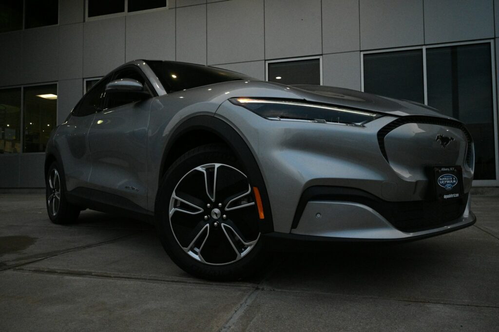a silver car parked in front of a building